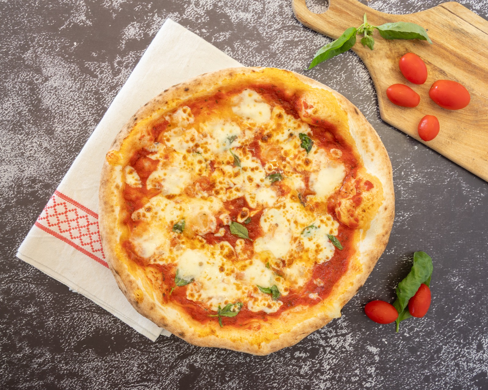 Wood-fired margherita pizza with cherry tomatoes and basil