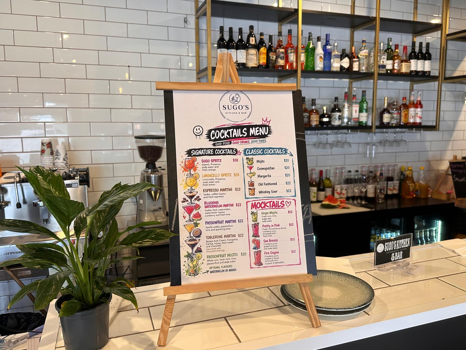 SUGO'S cocktails menu on an easel at the bar