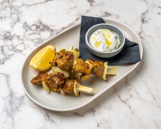 Lamb skewers with charred onion and labneh